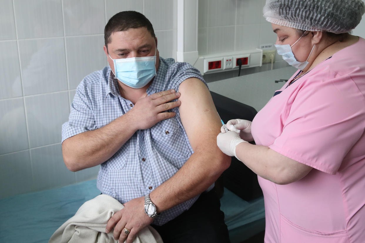 A man gets the Russian Sputnik V vaccine at the COVID-19 vaccination center at the Domodedovo central city hospital. (Photo by Valery Sharifulin\TASS via Getty Images)