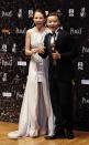 Chinese actor Zhang Jin and his wife actress Ada Choi react backstage after he won Best Supporting Actor for his role in the movie "The Grandmaster" at the 33rd Hong Kong Film Awards in Hong Kong April 13, 2014. REUTERS/Bobby Yip (CHINA - Tags: ENTERTAINMENT)