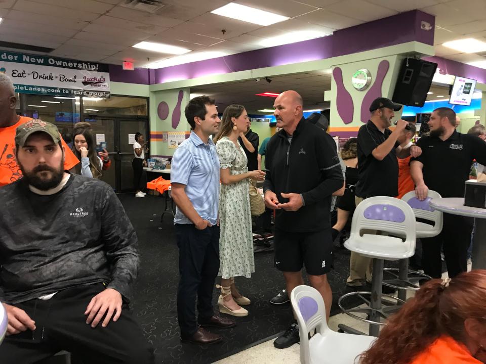 Former Tigers outfielder Kirk Gibson speaks with team president Scott Harris and his wife, Elle, during Willie Horton's charity bowling tournament at Orange Bowl Lanes in Lakeland, Fla., on March 9, 2023.