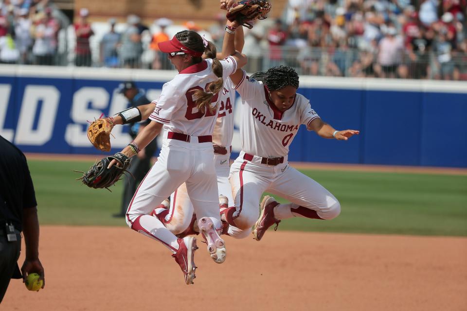 Oklahoma's Rylie Boone (0), Avery Hodge (82) and Jayda Coleman (24) celebrate after a softball game between the University of Oklahoma Sooners (OU) and Tennessee in the Women's College World Series at USA Softball Hall of Fame Stadium in Oklahoma City, Saturday, June 3, 2023. Oklahoma won 9-0.