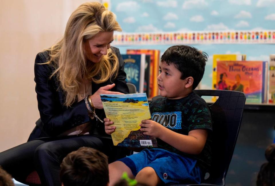 California First Partner Jennifer Siebel Newsom gives a bilingual storybook to Jose Maria Anguiano after reading it to him and other children Tuesday at the Arthur F. Turner Community Library in West Sacramento during an event announcing that Dolly Parton’s Imagination Library program, which provides free monthly books to children under age 5, would begin its statewide expansion.