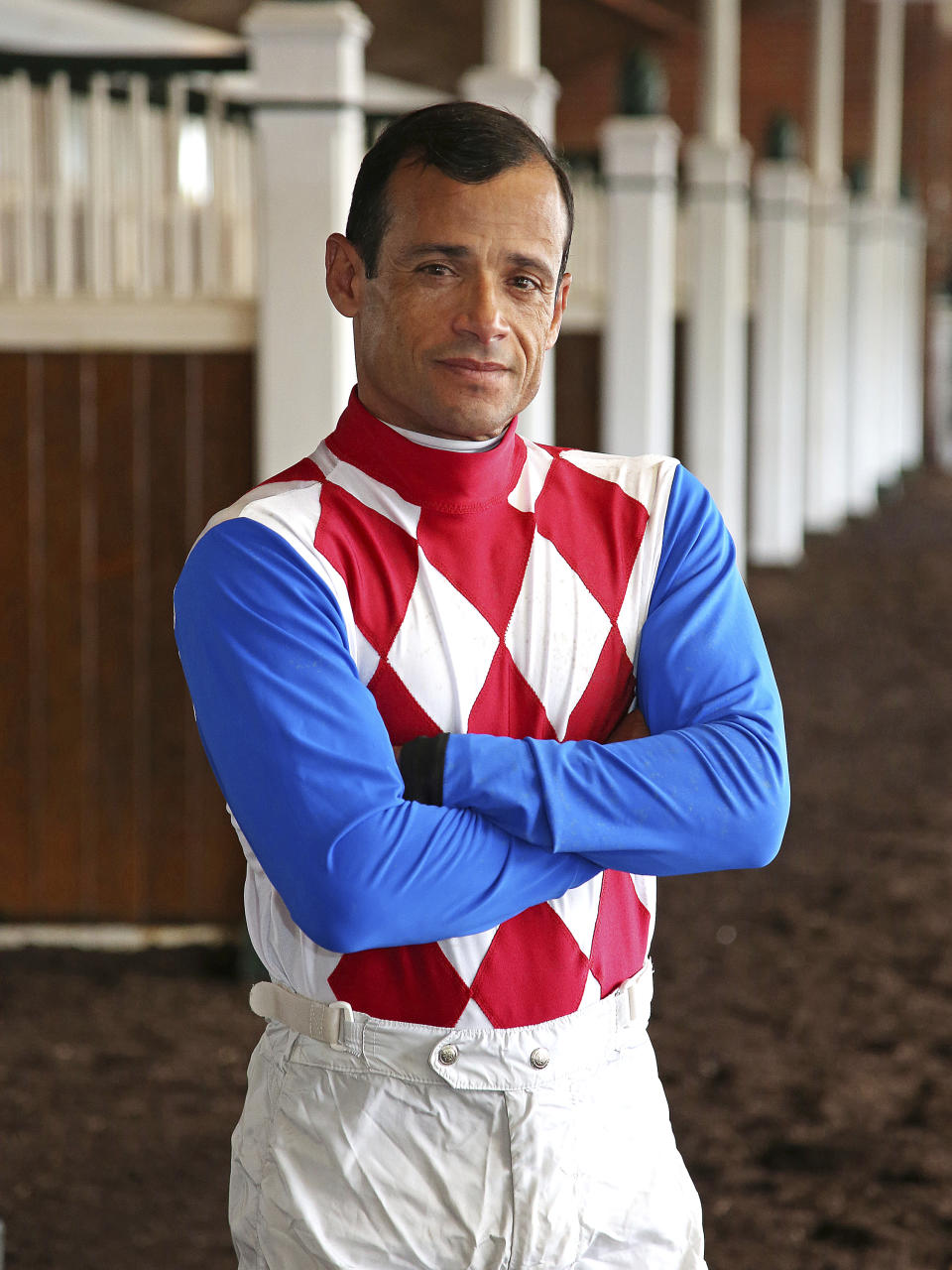 This photo provided by Equi-Photo shows jockey Jose Ferrer posed at Monmouth Park in Oceanport, N.J., Tuesday, June 15, 2021. Just look around the world of sports and athletes are winning events at older ages. Phil Mickelson won the PGA earlier this year at almost 51, and Tom Brady won another Super Bowl _ with the Tampa Bay Buccaneers this time _ at more than 43 in February. Jockey Jose Ferrer isn’t doing anything as grandiose. He’s just leading all jockeys in wins at Monmouth Park in New Jersey after 10 days of racing with 16 wins in 56 mounts. (Bill Denver/Equi-Photo via AP)