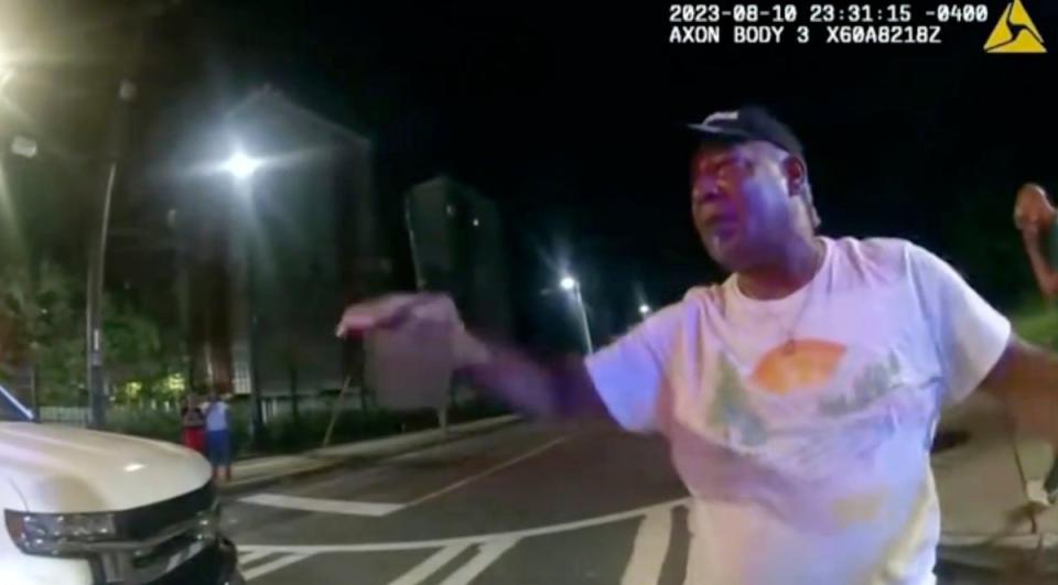This image from bodycam video provided by the Atlanta Police Department shows Johnny Hollman Sr. speaking with Officer Kiran Kimbrough on Aug. 10, 2023 in Atlanta (Atlanta Police Department)