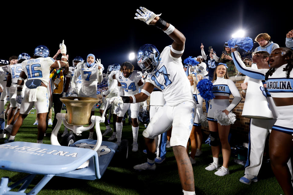 DURHAM, NC – OCTOBER 15: Chris Collins #17 of the North Carolina Tar Heels rings the victory bell following their 38-35 win against the Duke Blue Devils at Wallace Wade Stadium on October 15, 2022 in Durham, North Carolina. UNC won 38-35. (Photo by Lance King/Getty Images)