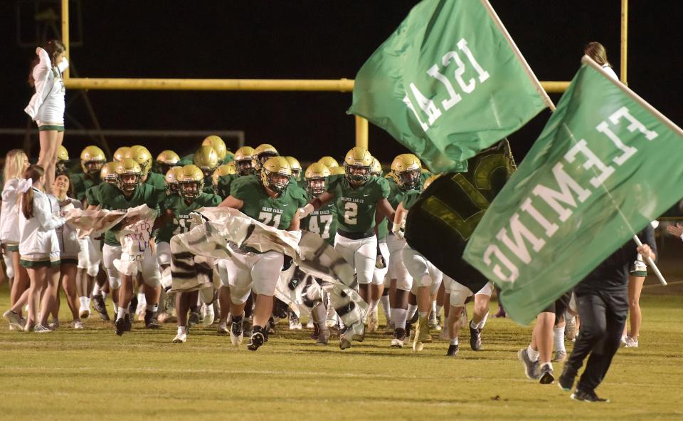 Fleming Island players run onto the field ahead of the start of Friday night's game against Oakleaf. Fleming Island High School hosted Oakleaf in High School football Friday, November 5, 2021.