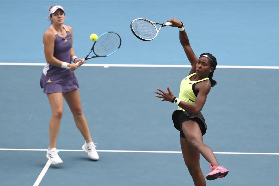 United States' Coco Gauff, right, and compatriot Caty McNally play in their third round doubles match against Japan's Shuko Aoyama and Ena Shibahara at the Australian Open tennis championship in Melbourne, Australia, Monday, Jan. 27, 2020. (AP Photo/Dita Alangkara)