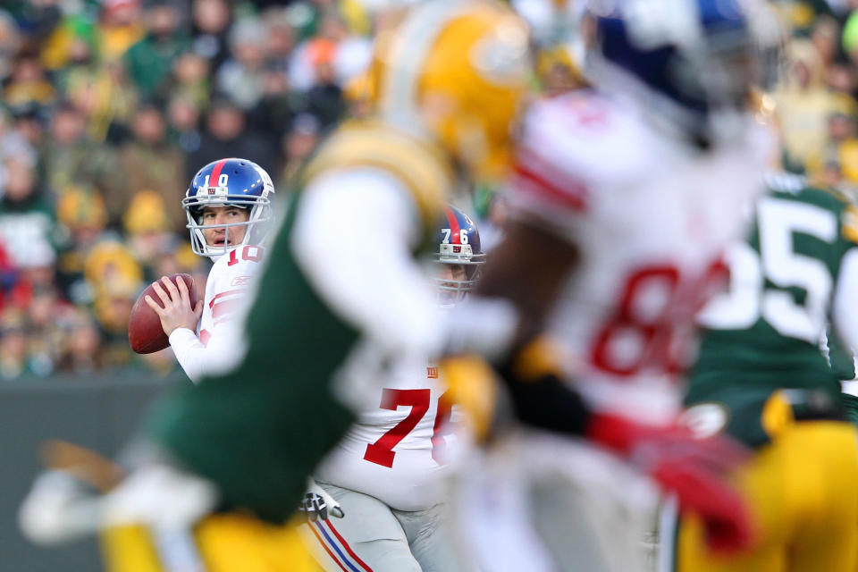 GREEN BAY, WI - JANUARY 15: Eli Manning #10 of the New York Giants drops back to pass against the Green Bay Packers during their NFC Divisional playoff game at Lambeau Field on January 15, 2012 in Green Bay, Wisconsin. (Photo by Jamie Squire/Getty Images)