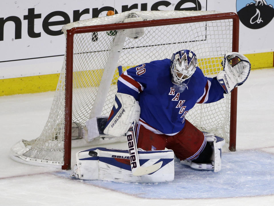 New York Rangers goalie Henrik Lundqvist (30), of Sweden, makes a save during the first period of Game 6 of a second-round NHL playoff hockey series against the Pittsburgh Penguins, Sunday, May 11, 2014, in New York. (AP Photo/Seth Wenig)