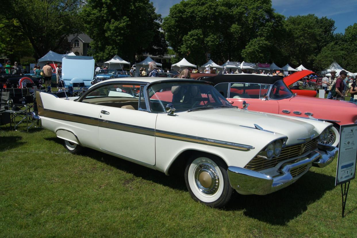 Off white 1958 Plymouth Fury at an outdoor car show