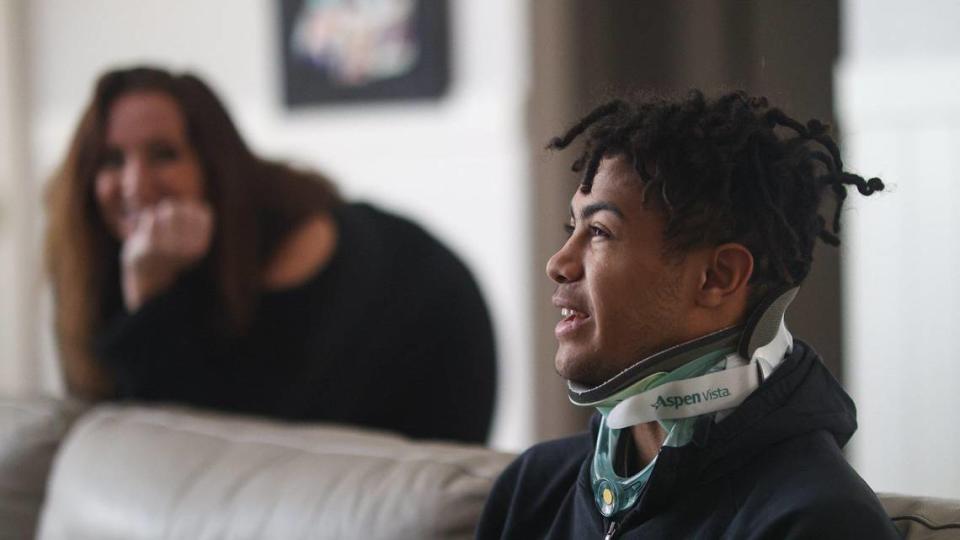 Jamar Howard is in a neck brace as he recovers from an injury suffered on the last play of Mission Prep’s state semifinal loss to Culver City. He’s using the time off from physical work to study the game and get healthy. At left is his mother, Jessica Smith.