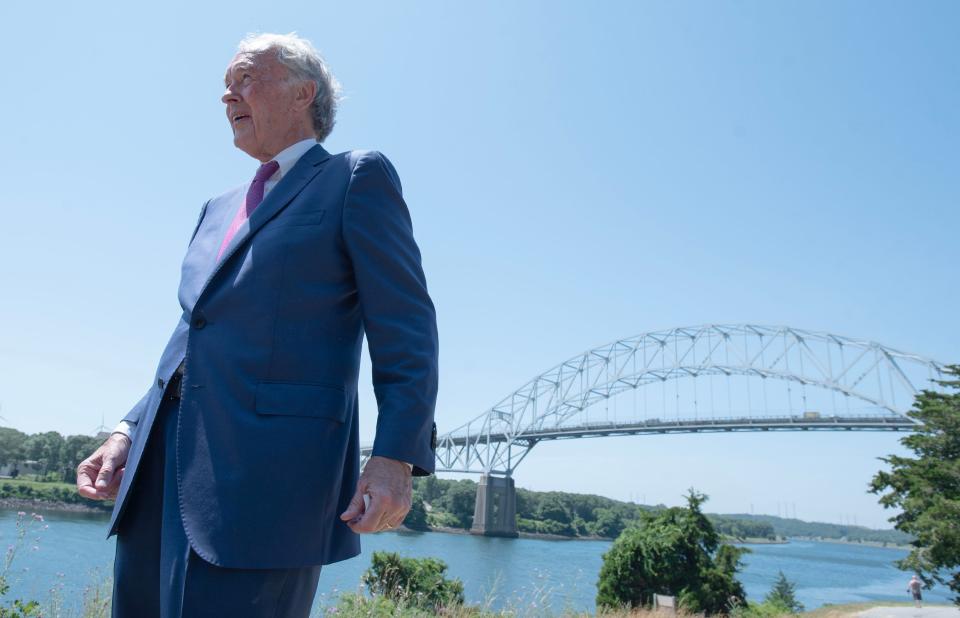 U.S. Senator Edward Markey, D-Massachusetts, stands alone Tuesday along the Cape Cod Canal in Sagamore Beach, with the Sagamore Bridge as backdrop, at a press conference highlighting the announcement that the funding has come through to replace the aging bridge.