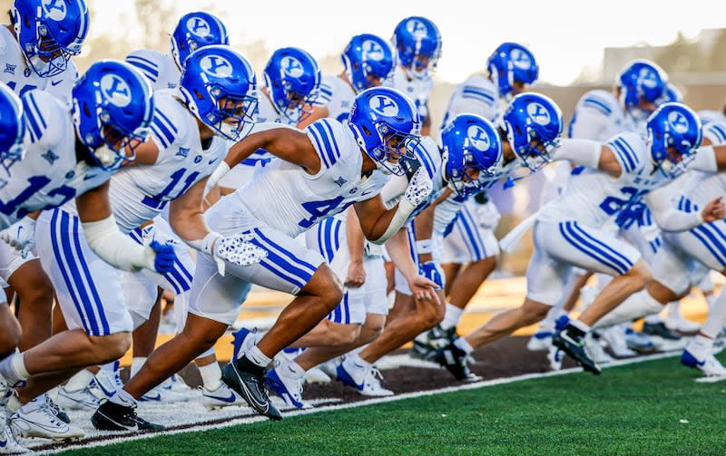 BYU football warms up before a game against Wyoming on Sept. 14, 2024, in Laramie. | BYU Photo