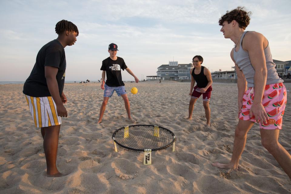 Daniel Marenga, Andrew Barry, RJ Portacion and Ben Dover, of Chelmsford High School, play Spike Ball in the sand.