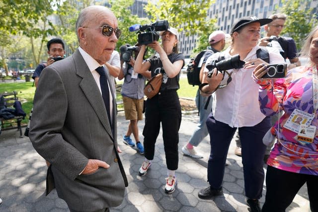 Tavistock founder Joe Lewis, left, is surrounded by photographers as he leaves court