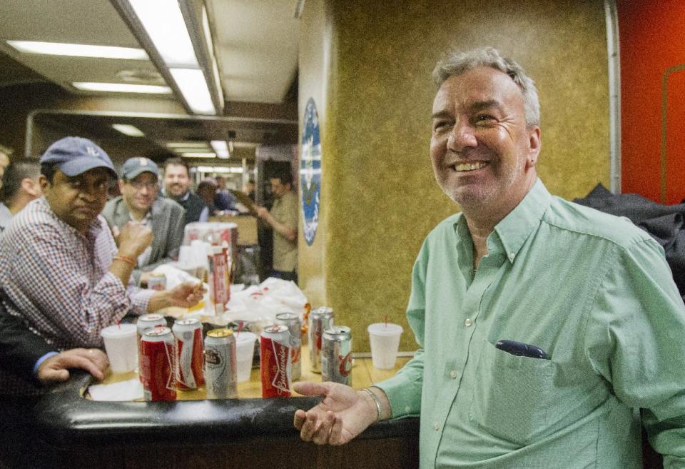 Mark DeMonte, right, of Wallingford, Conn., join other riders in the bar car on the 7:07 p.m. train to New Haven, Conn., at Grand Central Terminal on Thursday, May 8, 2014 in New York. DeMonte, a bar car regular, has been dubbed "Mayor of the 5:48" by friends and riders of his usual train. Metro-North is retiring bar cars from the New Haven Line after Friday's afternoon rush hour. They were the last commuter bar cars in the U.S. (AP Photo/Michael R. Sisak)