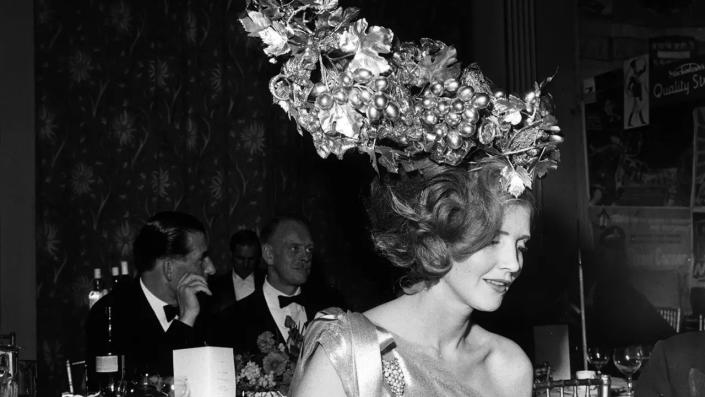 Lady Anne Glenconner wearing a funny hat at a party