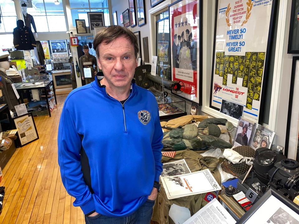 Filmmaker Tim Gray, surrounded by World War II memorabilia at his museum. His 18-minute virtual reality program puts the viewer on a D-Day landing craft.