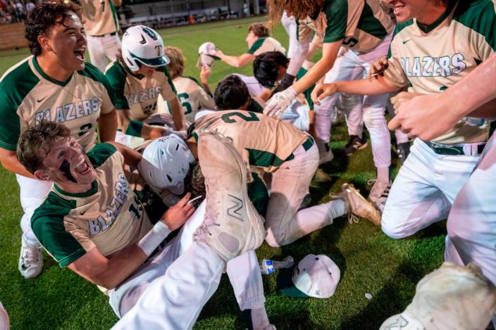 Timberline players dogpile on top of Gage Reeser after his walk-off single in the bottom of the seventh inning helped the Blazers beat Stadium, 7-6, in the 3A West Central/Southwest district baseball championship game at Auburn High School on Saturday, May 13, 2023, in Auburn, Wash. Pete Caster/Pete Caster / The News Tribune