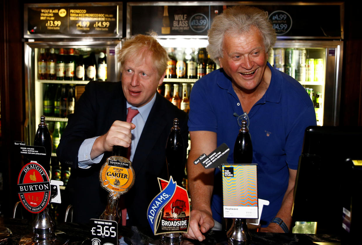 Boris Johnson, a leadership candidate for Britain's Conservative Party, and JD Wetherspoon chairman Tim Martin draft a beer together at Wetherspoons Metropolitan Bar in London, Britain, July 10, 2019. REUTERS/Henry Nicholls/pool