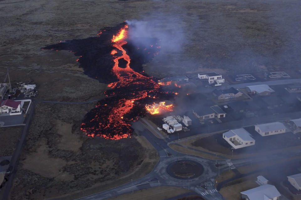 In this image made from video, volcanic activity is seen in Grindavik, Iceland, Sunday, Jan. 14, 2024. Iceland’s president says the country is battling “tremendous forces of nature” after molten lava from a volcano consumed several houses in the evacuated town of Grindavik. (Bjorn Steinbekk via AP)