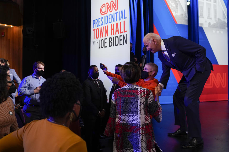 President Joe Biden greets people during a break as he participates in a CNN town hall at the Baltimore Center Stage Pearlstone Theater, Thursday, Oct. 21, 2021, in Baltimore. (AP Photo/Evan Vucci)