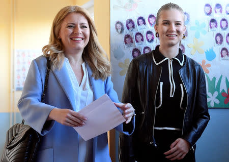 Slovakia's presidential candidate Zuzana Caputova stands next to her daughter as she attends the country's presidential election run-off at a polling station in Pezinok, Slovakia, March 30, 2019. REUTERS/Radovan Stoklasa?