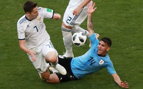 Russia's Daler Kuzyayev (L) and Uruguay's Lucas Torreira in action in their 2018 FIFA World Cup Group A football match at Samara Arena Stadium. Sergei Fadeichev - Credit: Getty Images
