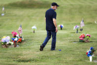 Eddie Davis walks past tributes on his way to his son Jeremy's gravestone, who died from the abuse of opioids, Wednesday, July 17, 2019, in Coalton, Ohio. Newly released prescription opioid statistics underscore how widespread pill use has been in towns and small cities of America’s Appalachian region. In Jackson County, an average yearly total of 107 opioid pills for every resident were distributed over a seven-year period. (AP Photo/John Minchillo)