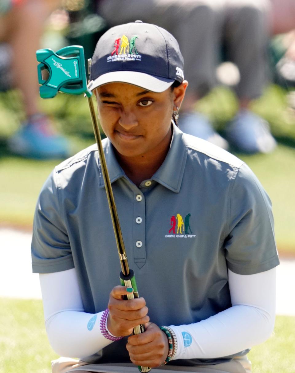 Kayley Roberts from Phoenixville, Pa., lines up her putt during the Drive, Chip & Putt National Finals competition at Augusta National Golf Club.