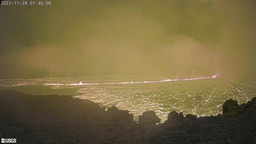 An image taken by a webcam situated along the northwest rim of the summit caldera of Hawaii's Mauna Loa volcano early on November 28, 2022 shows an eruption which, at the time, was confined to the crater. / Credit: USGS