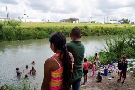 FILE PHOTO: People bathe and wash clothes in the Rio Grande in Matamoros, Tamaulipas.