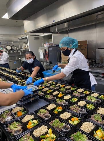 The duchess helped pack meal boxes. (Duke and Duchess of Sussex)