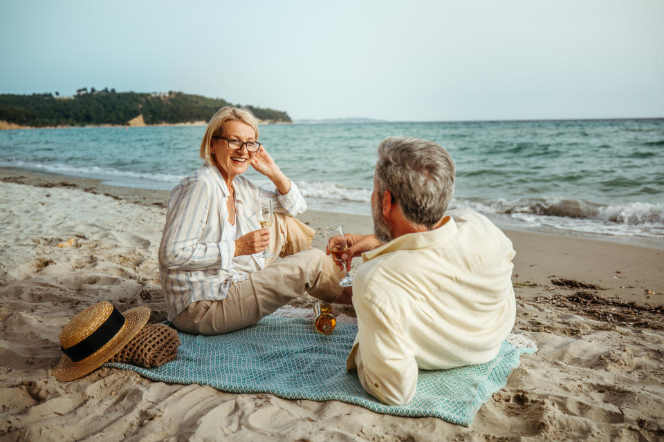 Mature couple enjoying picnic on a beach