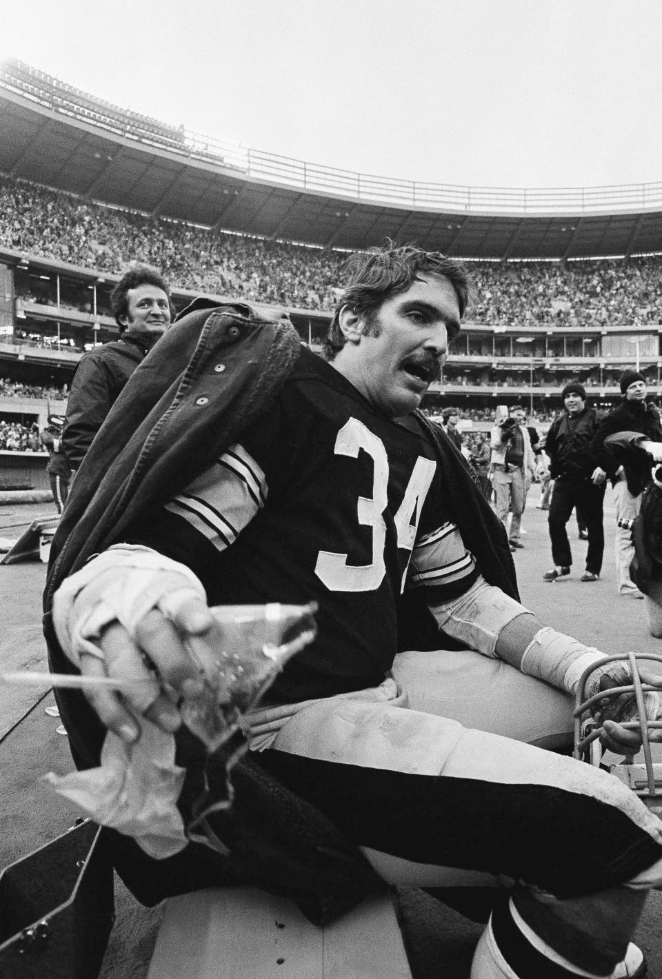 FILE - Steelers linebacker Andy Russell takes a break on the bench during fourth quarter action with the Baltimore Colts at Pittsburgh, Dec. 27, 1975. The Steelers announced Saturday, March 2, 2024 that Russell, a seven-time Pro Bowler and two-time Super Bowl winner during his 12-year career, has died at 82. (AP Photo, File)