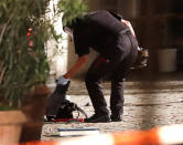 <p>A special police officer examines a backpack at the entrance of a building in Ansbach, Germany, Monday, July 25, 2016. (AP Photo/Matthias Schrader)</p>