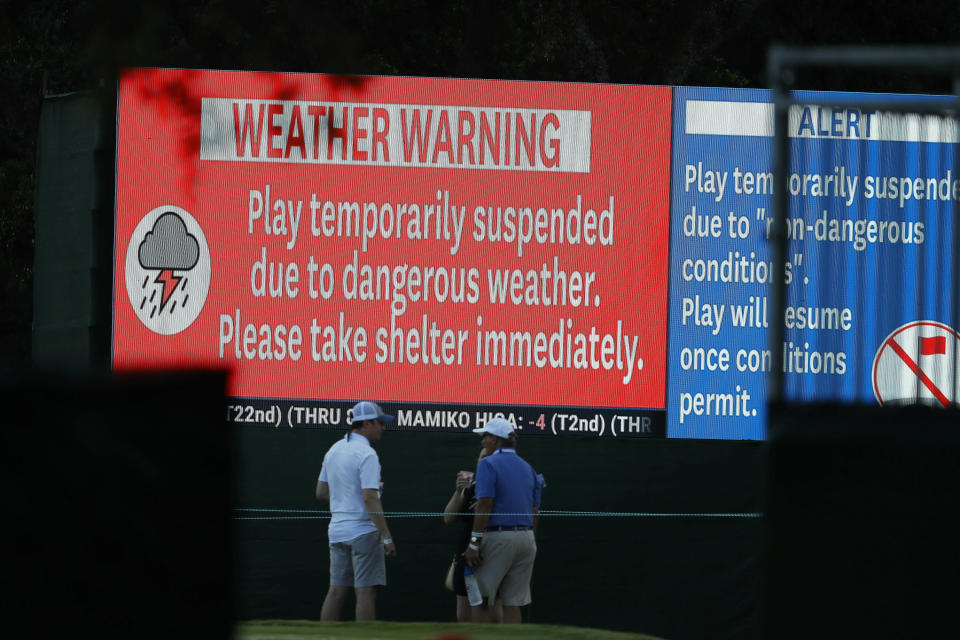 Spectators and golfers leave the course due to inclement weather during the second round of the U.S. Women's Open golf tournament, Friday, May 31, 2019, in Charleston, S.C. (AP Photo/Steve Helber)