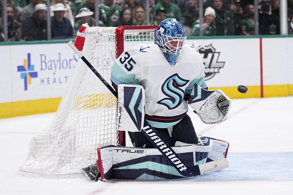 Seattle Kraken goaltender Joey Daccord (35) defends against a shot by the Dallas Stars in the first period of an NHL hockey game, Tuesday, March 21, 2023, in Dallas. (AP Photo/Tony Gutierrez)