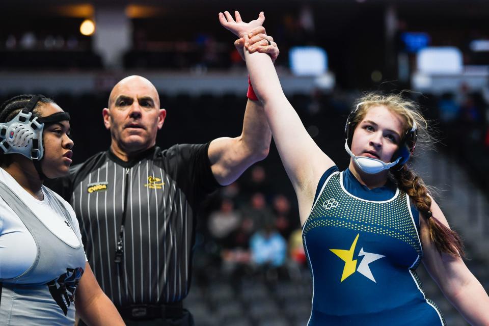 Poudre School District's Mariah Gonzales, right, is shown the winner after defeating Harrison's Alicia Rowe by a first round fall at the Colorado state high school wrestling tournament at Ball Arena on Thursday, Feb. 16, 2023 in Denver, Colo. Gonzales won by fall in the first round.