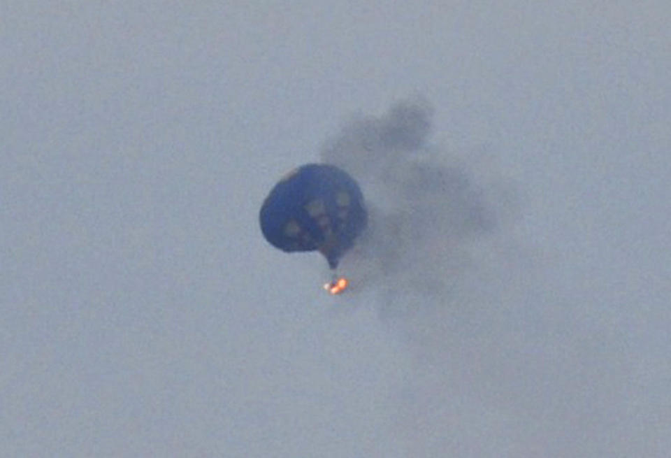 A hot air balloon on fire is pictured north of Richmond, Virginia, May 9, 2014, in this handout photo courtesy of Lynn Shultz. At least one person died and two were missing after the hot air balloon hit a power line and caught fire over Virginia during a festival, police said on Saturday. Authorities said they had found the remains of one person, and were continuing to search for the others missing after the Friday evening accident 30 miles north of Richmond. Mandatory Credit. REUTERS/Lynn Shultz/Handout via Reuters (UNITED STATES - Tags: DISASTER SOCIETY TRANSPORT TPX IMAGES OF THE DAY) ATTENTION EDITORS - NO SALES. NO ARCHIVES. FOR EDITORIAL USE ONLY. NOT FOR SALE FOR MARKETING OR ADVERTISING CAMPAIGNS. THIS PICTURE WAS PROVIDED BY A THIRD PARTY. REUTERS IS UNABLE TO INDEPENDENTLY VERIFY THE AUTHENTICITY, CONTENT, LOCATION OR DATE OF THIS IMAGE. THIS PICTURE WAS PROCESSED BY REUTERS TO ENHANCE QUALITY. AN UNPROCESSED VERSION WILL BE PROVIDED SEPARATELY. MANDATORY CREDIT