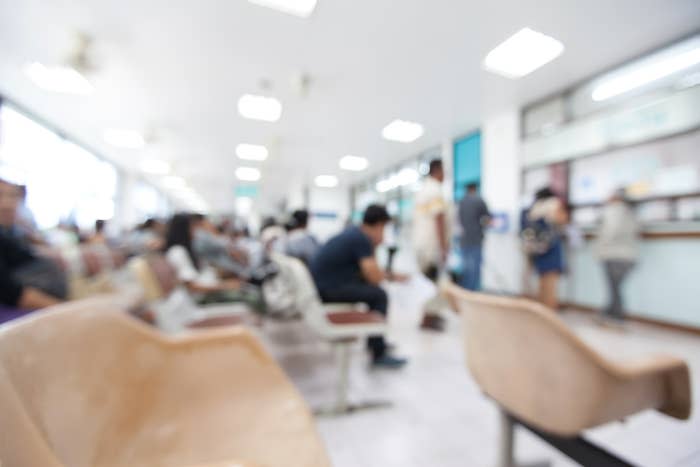 Close up shot of woman using phone in waiting room