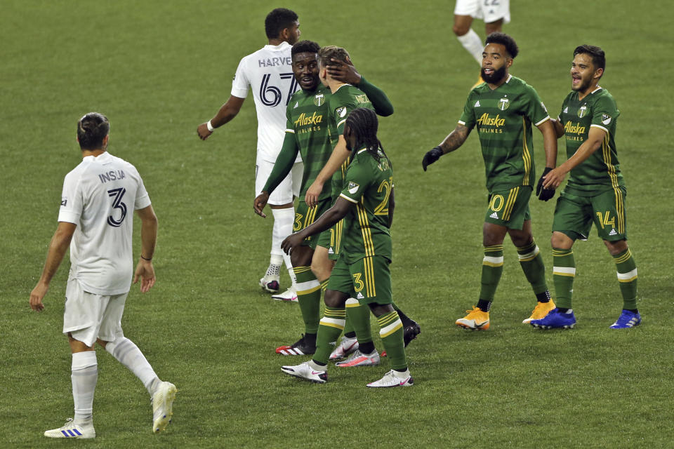 Portland Timbers players celebrate Jaroslaw Niezgoda's goal against the LA Galaxy during the first half of an MLS soccer match Wednesday, Oct. 28, 2020, in Portland, Ore. (Sean Meagher/The Oregonian via AP)