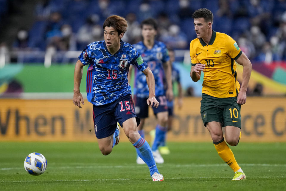 FILE - Japan's Yuya Osako, left, and Australia's Ajdin Hrustic battle for the ball during their World Cup 2022 group B qualifying soccer match between Australia and Japan at Saitama Stadium in Saitama, north of Tokyo, Tuesday, Oct. 12, 2021. (AP Photo/Shuji Kajiyama, File)