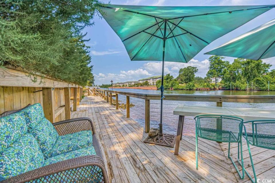 A home surrounded by trees and overlooking the Intracoastal Waterway near North Myrtle Beach is listed for $825,000. Built in 1979, the house has three bedrooms and a dock. Provided photo. Dec. 12, 2023.