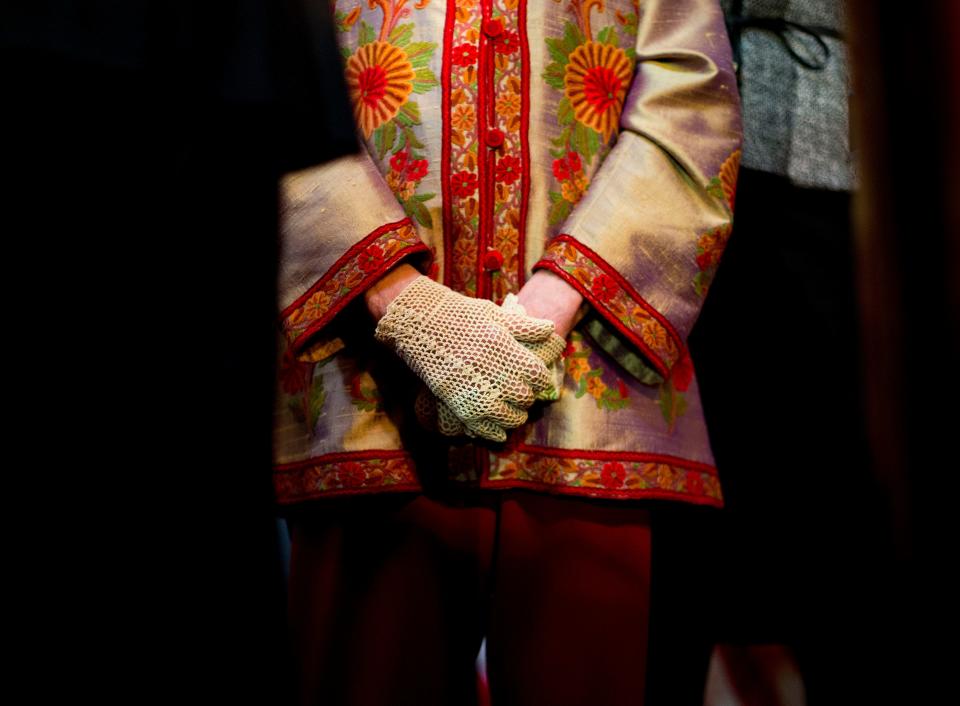 Associate Justice Ruth Bader Ginsburg, center, stands during the annual Women's History Month reception at Statuary Hall on Capitol Hill in Washington, March 18, 2015. A collection of nearly 100 items is being sold in an online auction that begins Wednesday, Sept. 7, 2022, and runs through Sept. 16, including a pair of cream-colored gloves owned by Ginsburg, not the pair shown above. One of her collars is also up for auction.