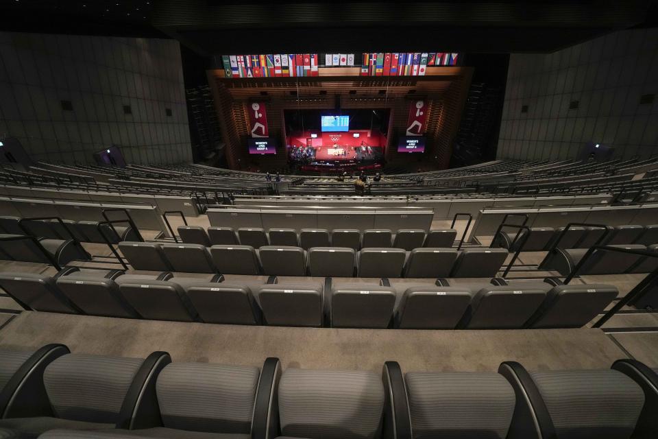 FILE - In this July 24, 2021, file photo, seats sit empty during the women's 49kg weightlifting event, at the Tokyo International Forum , during the 2020 Summer Olympics in Tokyo, Japan. In arenas across Tokyo, athletes accustomed to feeding off the deafening roar of the crowd are searching for new ways to feel Olympic enthusiasm. (AP Photo/Luca Bruno, File)