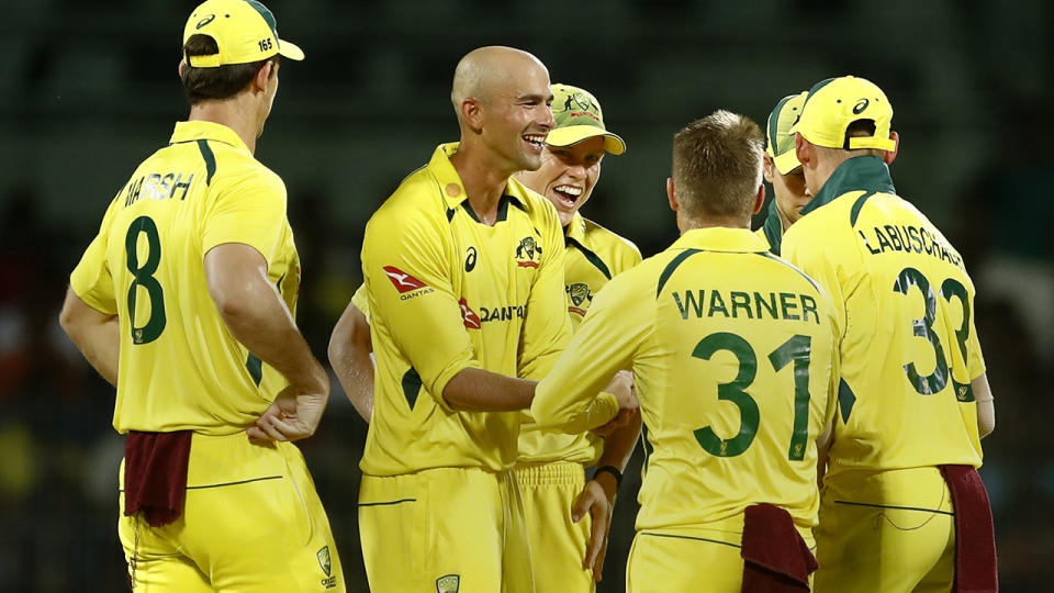 Ashton Agar celebrates a wicket with Australian teammates.