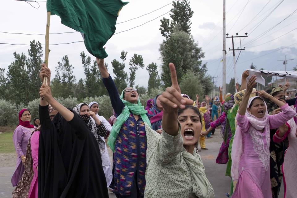FILE- In this Aug. 9, 2019 file photo, Kashmiri women shout slogans protesting against India's decision to strip Kashmir of its autonomy as they march on a street after Friday prayers in Srinagar, Indian controlled Kashmir. The beautiful Himalayan valley is flooded with soldiers and roadblocks of razor wire. Phone lines are cut, internet connections switched off, politicians arrested. Narendra Modi, the prime minister of the world’s largest democracy has clamped down on Kashmir to near-totalitarian levels. (AP Photo/ Dar Yasin, file)