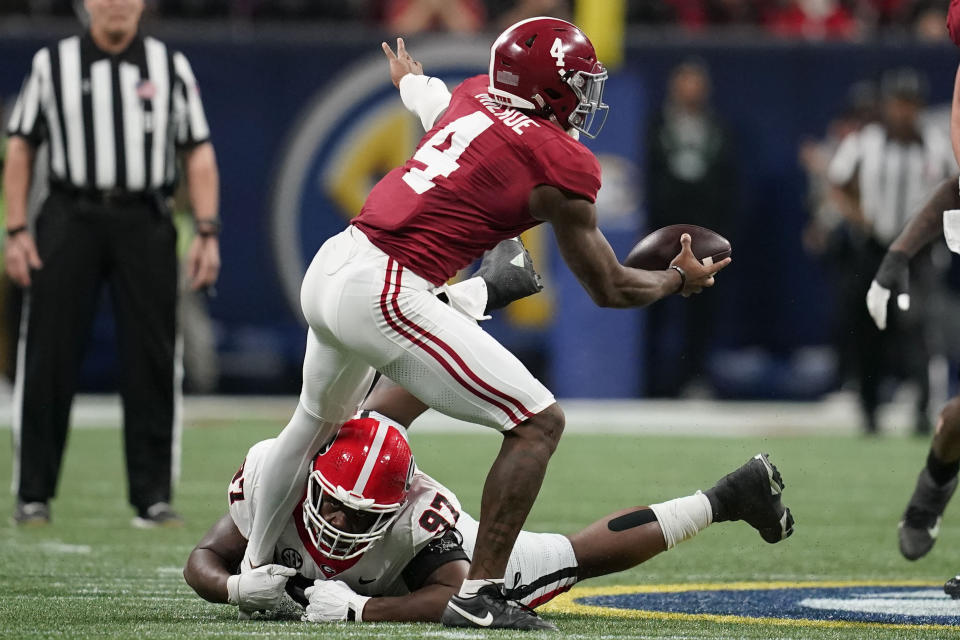 Georgia defensive lineman Warren Brinson (97) sacks Alabama quarterback Jalen Milroe (4) during the first half of the Southeastern Conference championship NCAA college football game in Atlanta, Saturday, Dec. 2, 2023. (AP Photo/Mike Stewart)