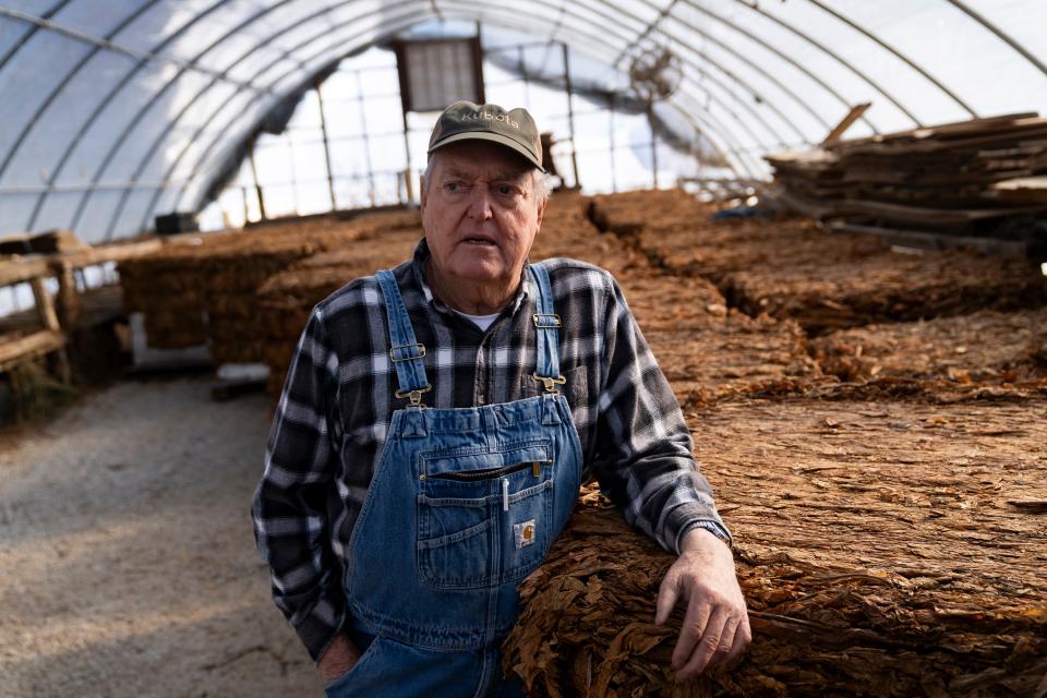 Paul Dennison, owner of Dennison’s Roadside Market, stands in front of his baled tobacco on Jan. 22, 2024, in Hart County, Kentucky. “A lot of people don’t really have a clue what goes on on the farm or how stressful it is,” Dennison said.