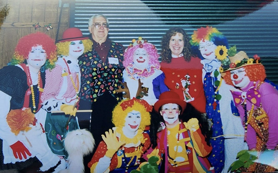 J.P. Hall Jr. and daughter Virginia Hall join some happy clowns for the annual Clay County Christmas charity event in this undated photo.
